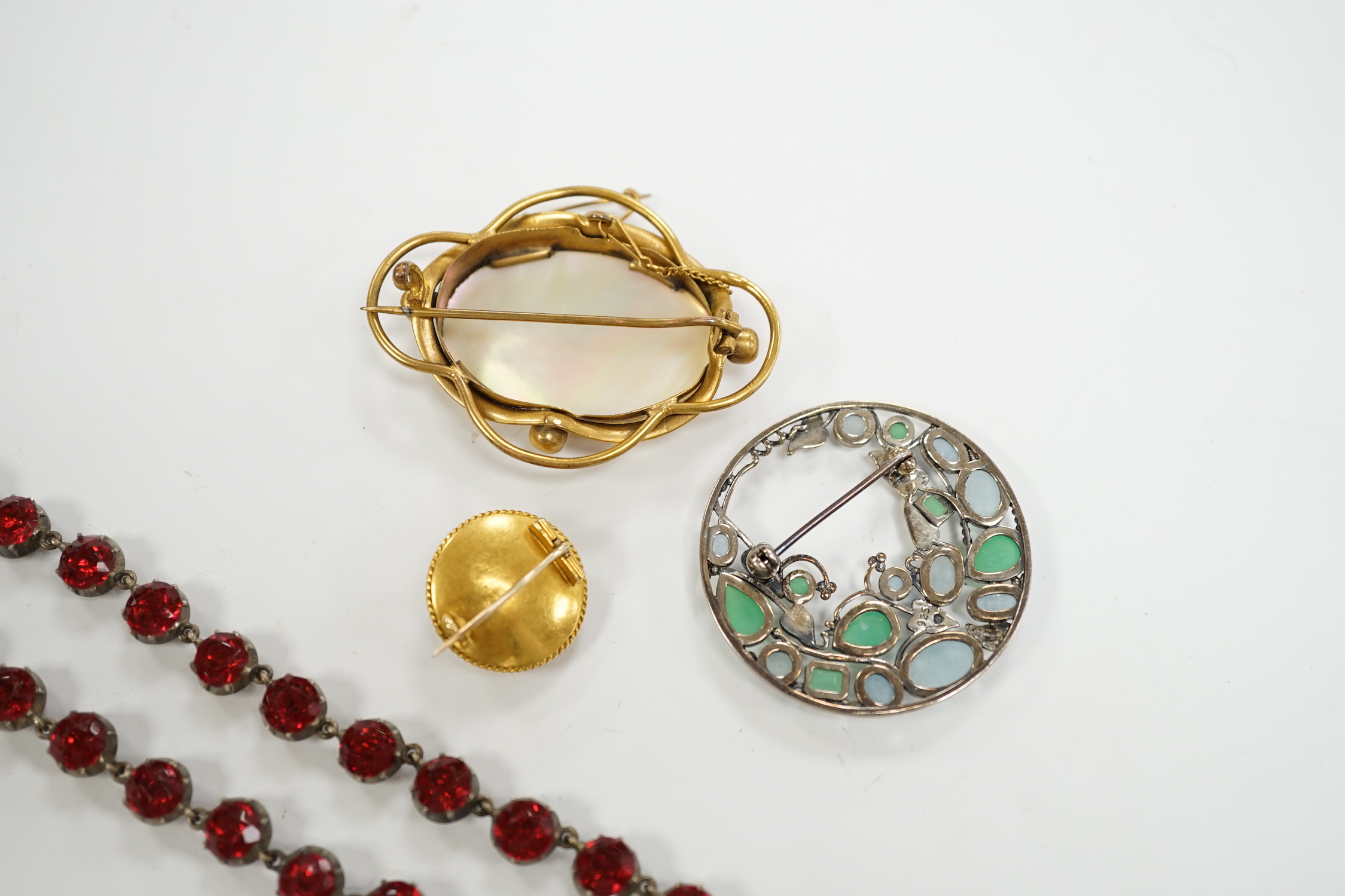 A late Victorian yellow metal, enamel and split pearl set circular brooch, 18mm, a modern 925 and gem set Sibyl Dunlop style brooch and two other items.